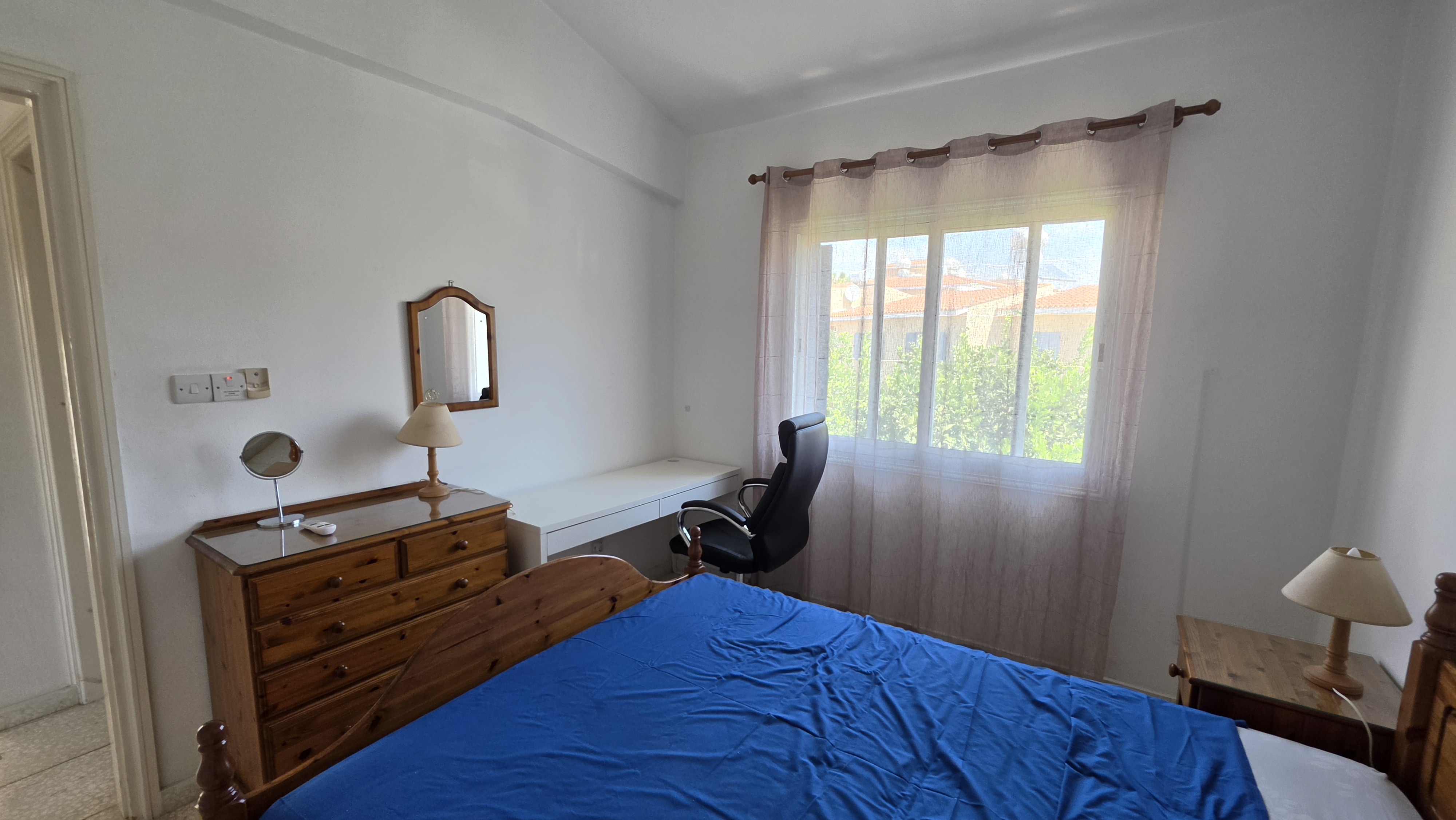 Double bedroom at Villa Nadezda with desk and a view over the gardens