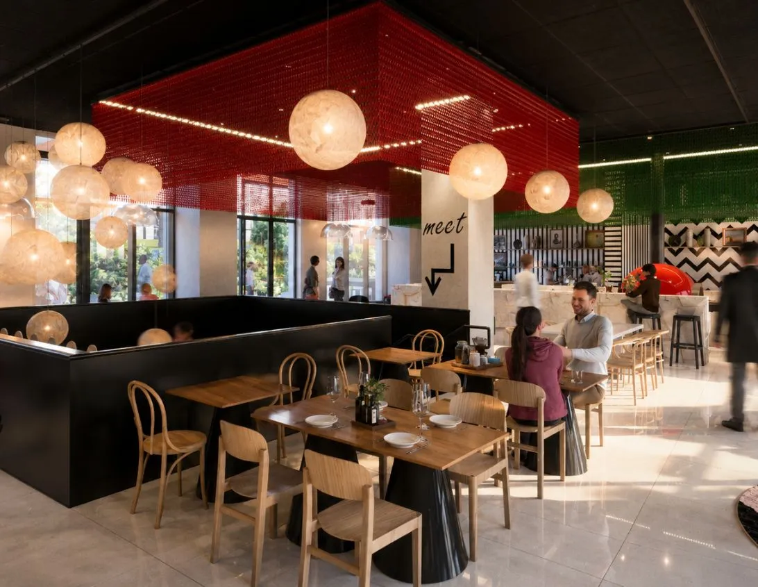 Dining room of the Ysotop restaurant in Grenoble with black banquettes and red ceiling with pearly pendant lights.