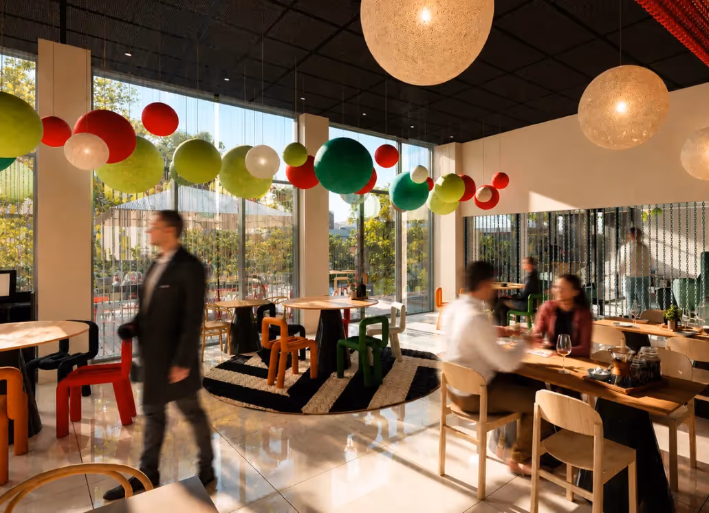The dining room of the Italian restaurant at the Ysotop Hotel in Grenoble, with its colorful red and green pendant lights.
