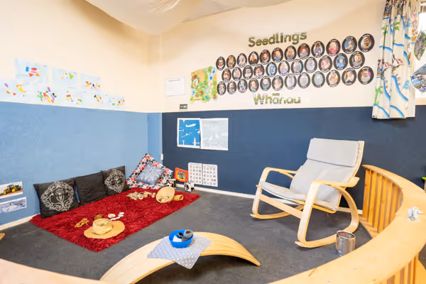 The Seedlings room at Willows, with a cosy reading corner and nursing chair