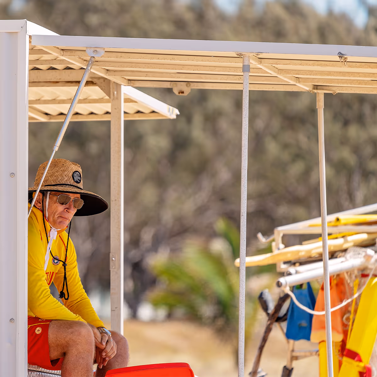 surf life saver sitting on beach