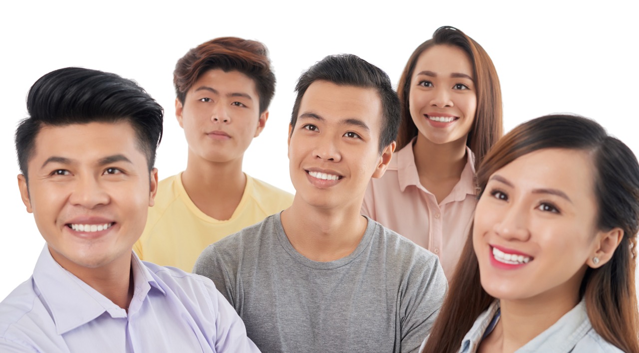 Group of five young adults smiling and looking slightly to the left on a white background.