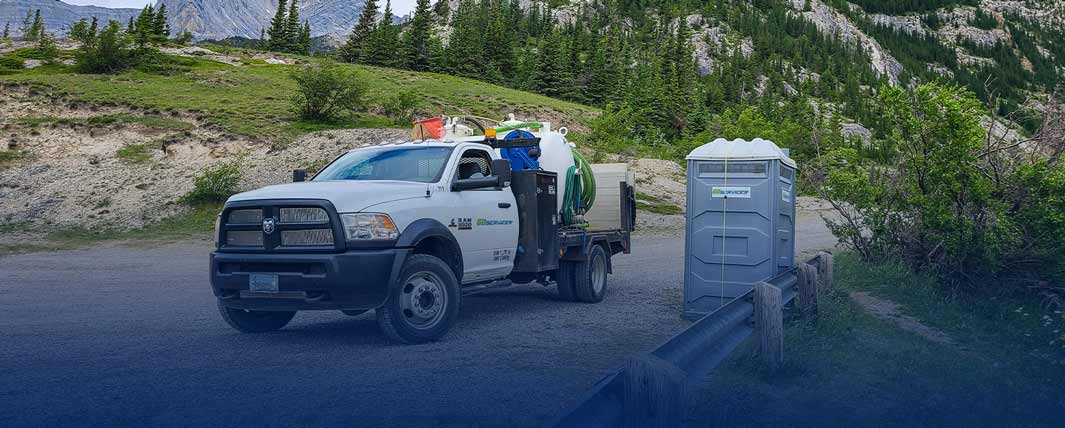 Service truck parked beside portable equipment