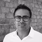 a man wearing glasses and a white shirt