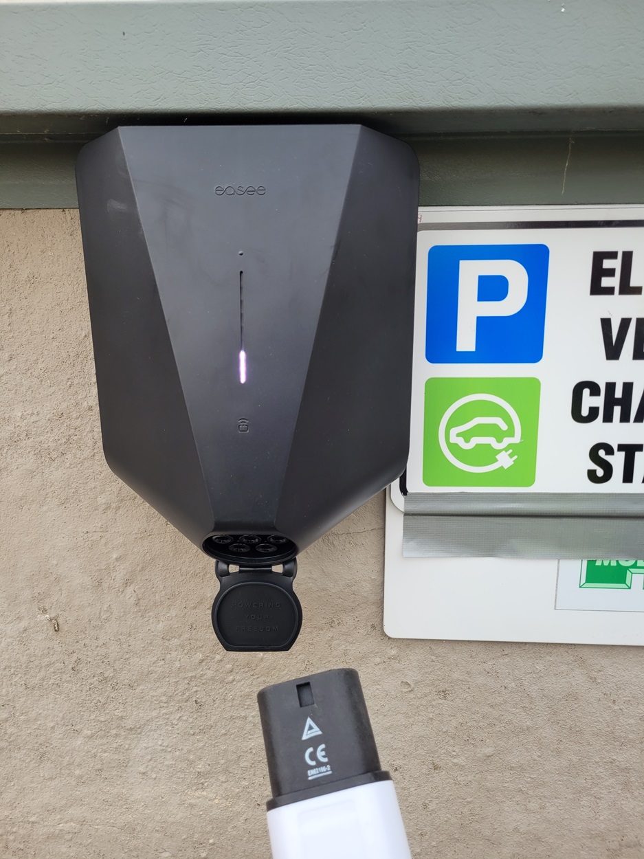 business ev charge point installation mounted to wall with ev charging signage