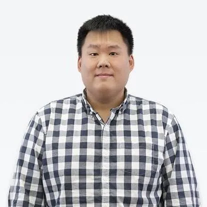 Man wearing a black and white checkered shirt against a plain white background.