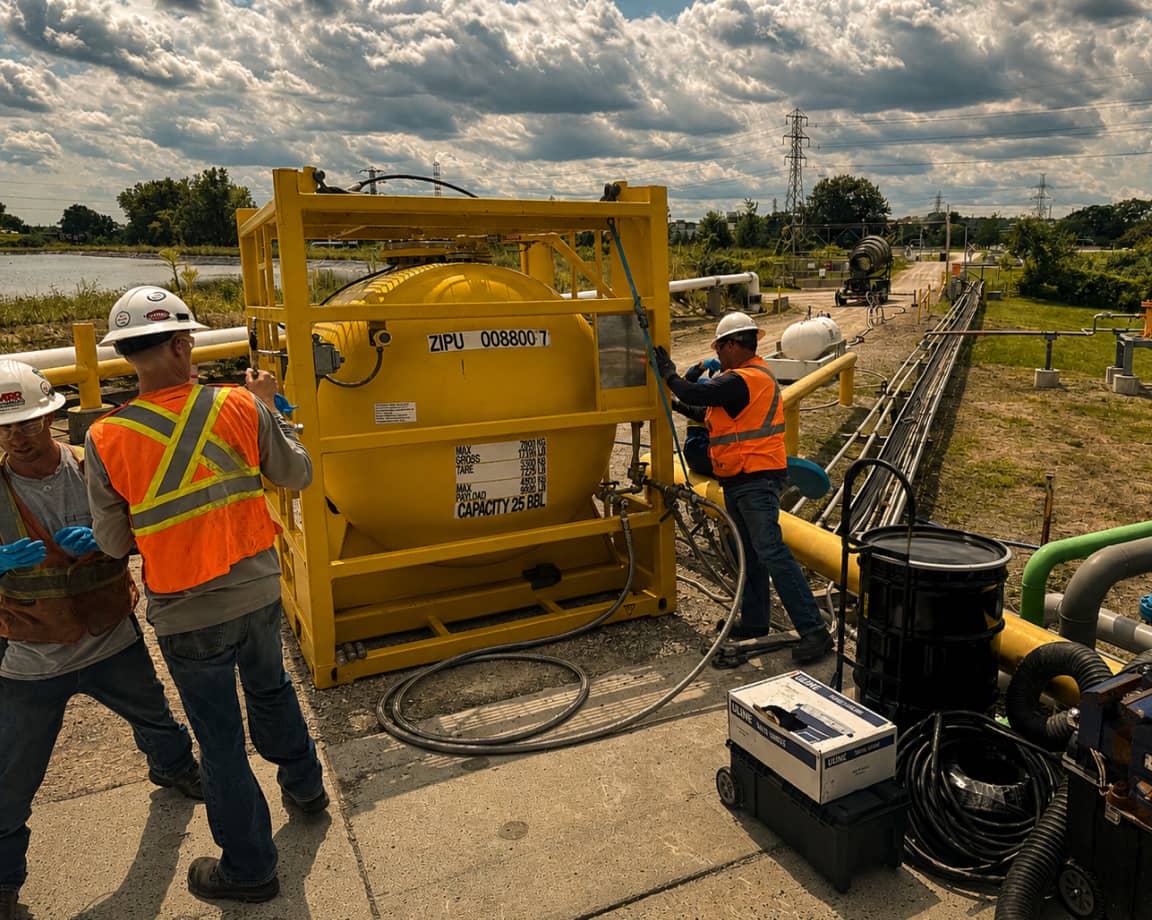 MRR crew connecting a portable odorant tote at a refinery site