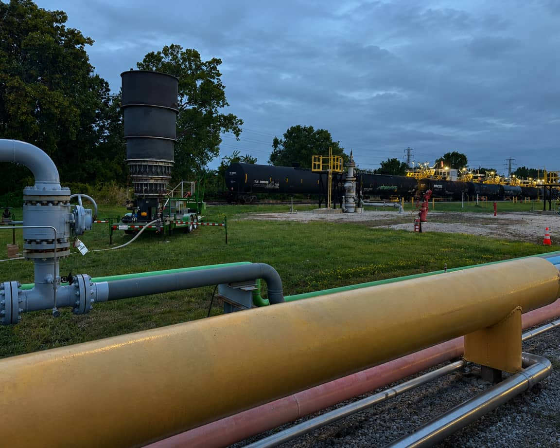 Pipeline odorization equipment with scrubber tower and railcar near a refinery