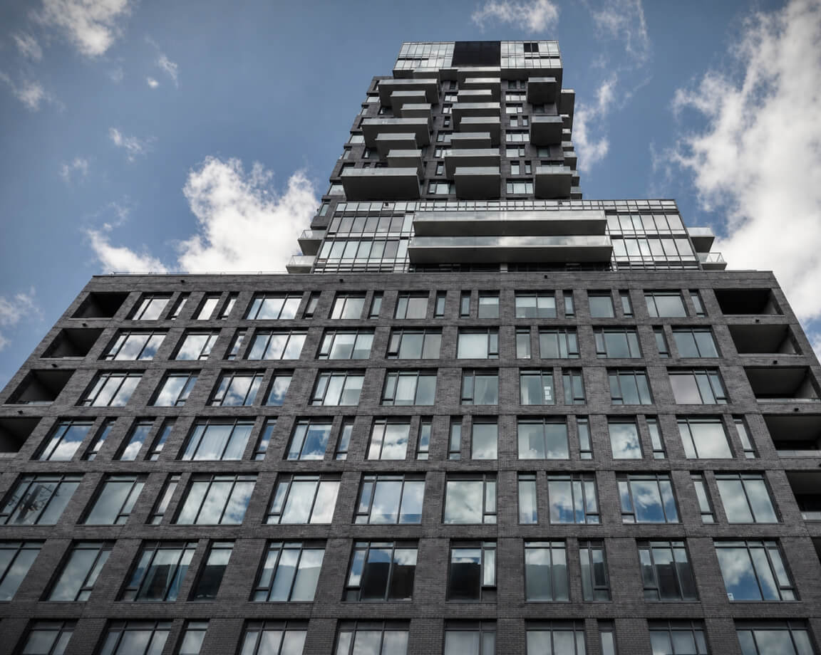 Upward view of a high-rise residential building facade
