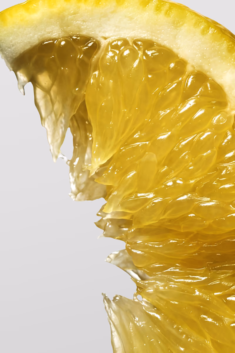 Close-up of a juicy yellow lemon slice showing pulp and rind details.