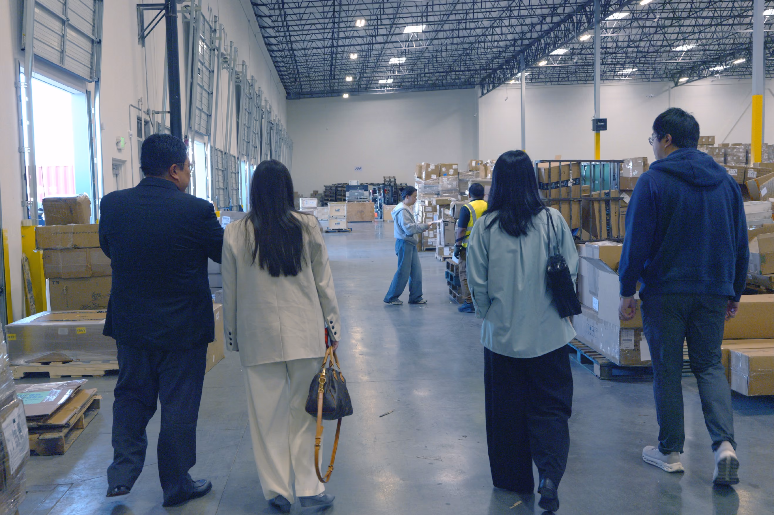 On-site QC engineer and factory manager reviewing inspection points on a tablet