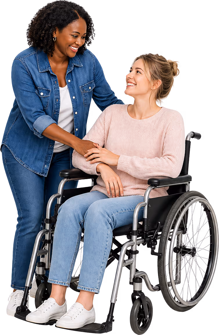 Smiling woman in denim jacket supporting and holding hands with a woman sitting in a wheelchair wearing a pink sweater and light blue jeans.