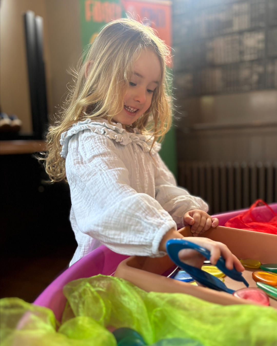 Engaged child playing at Fidget and Spin Squish and Squeeze zone