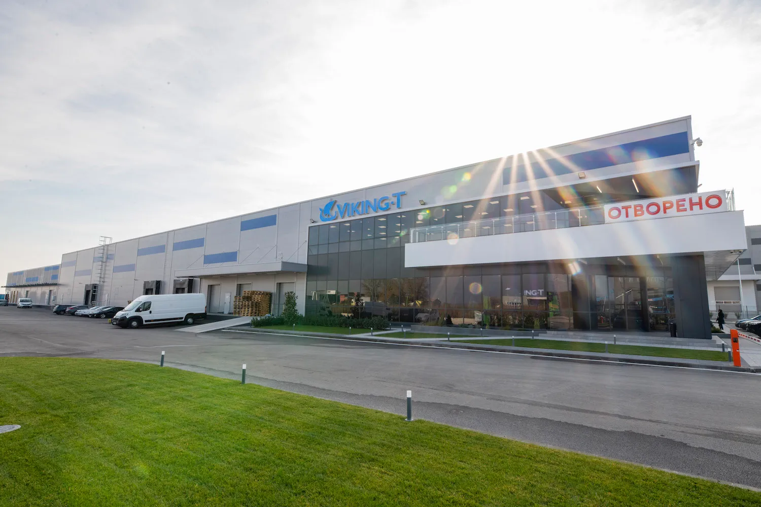 Viking-T warehouse and retail building with glass storefront, company signage, and delivery van in parking area