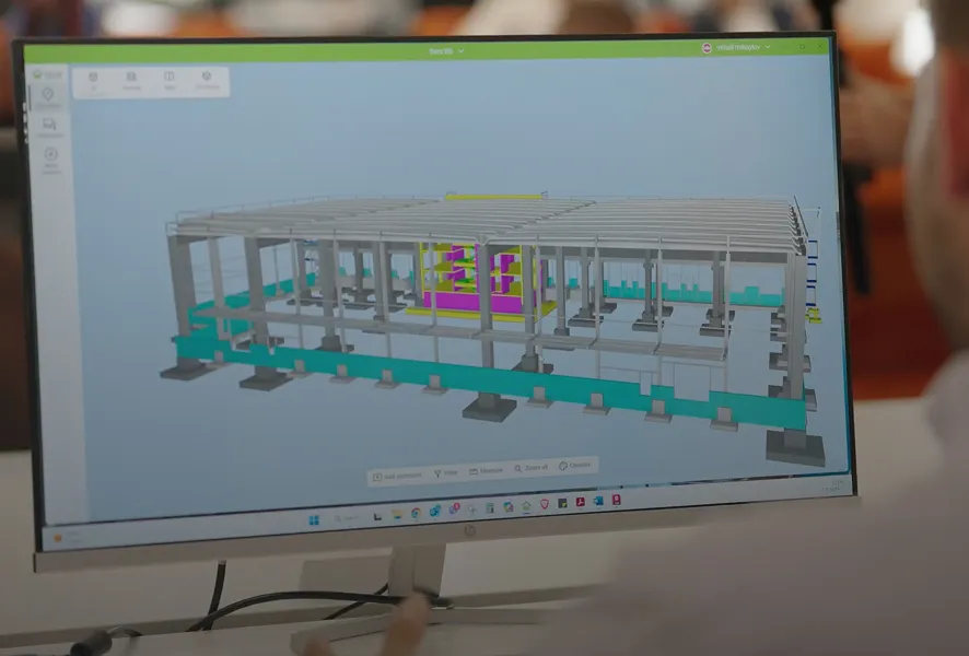 Computer screen showing a 3D model of a building structure with columns and beams in a design software.