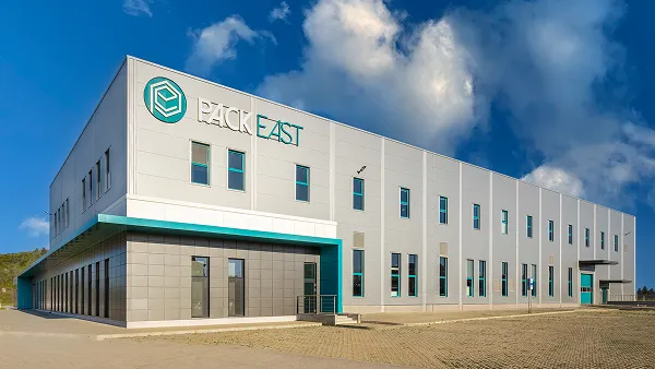 PACK EAST company building with a modern white and teal facade.