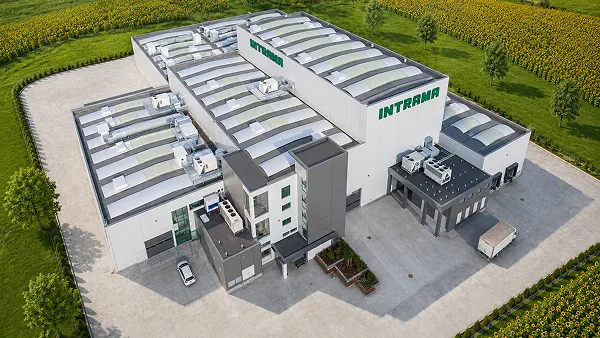 Aerial view of the INTRAMA factory complex surrounded by fields.