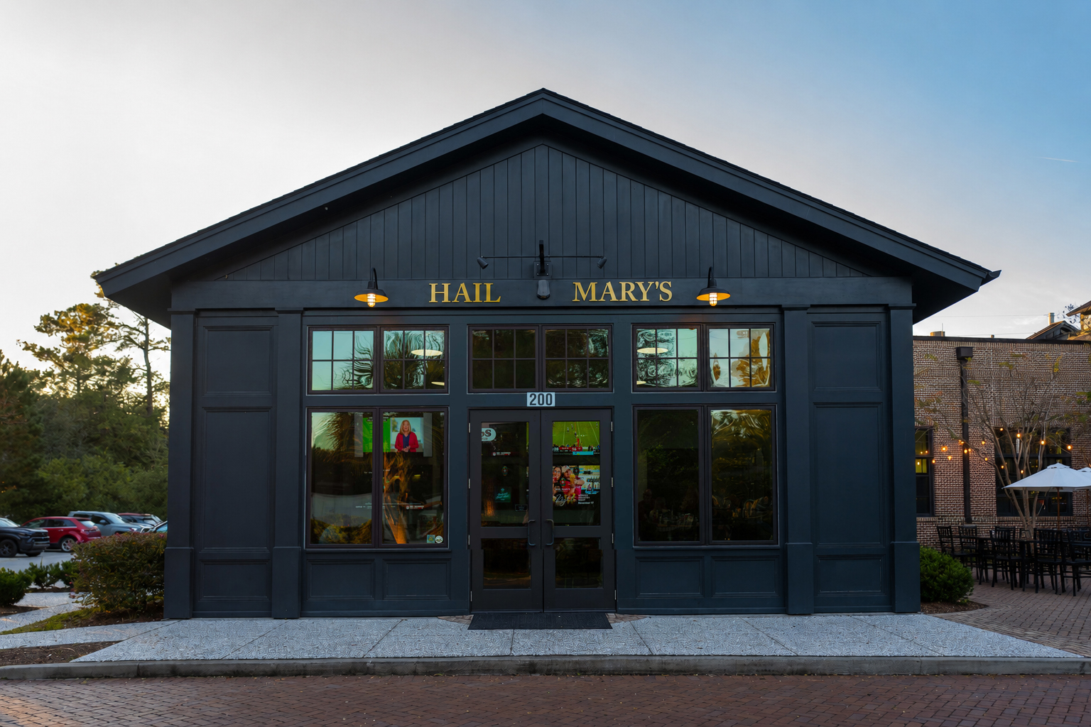 Black building with windows and door labeled Hail Mary's and number 200 above the door.