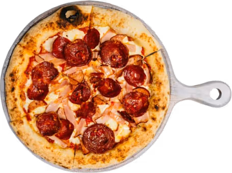 Pizza topped with prosciutto, cheese, arugula, and shaved Parmesan on a wooden peel.