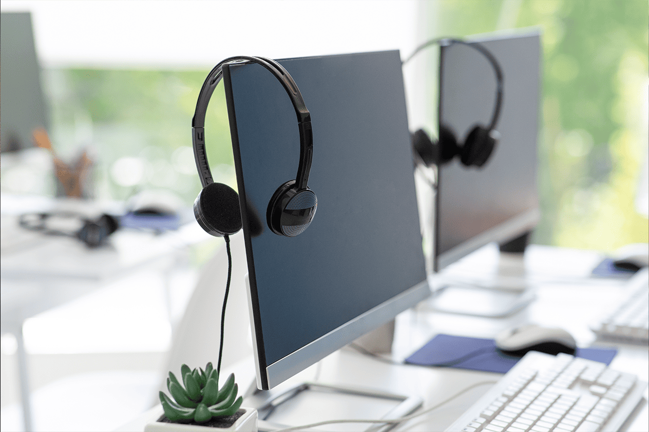 Photograph of monitors wearing headphones designed specifically for call centres