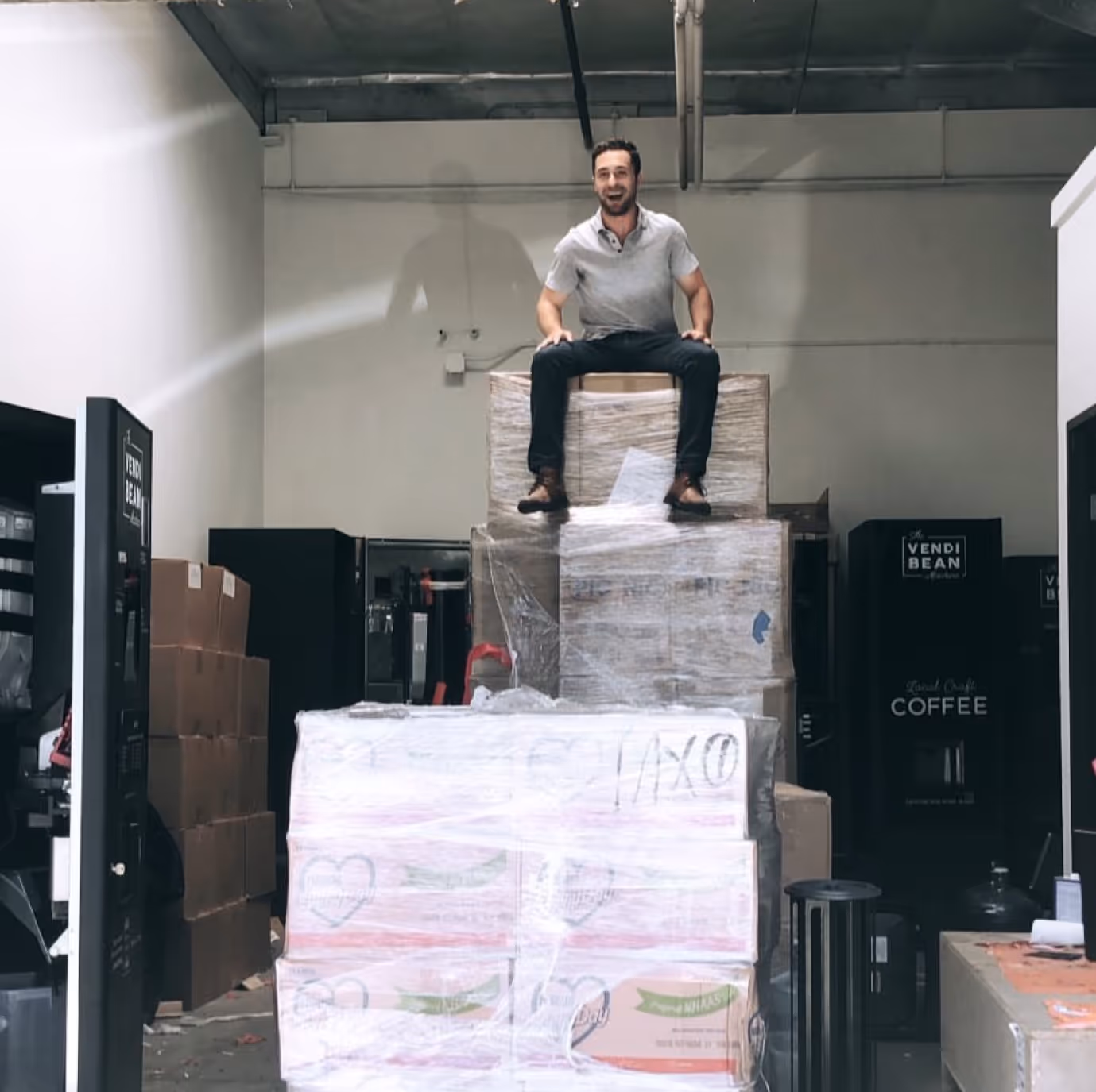 a man sitting on a stack of boxes