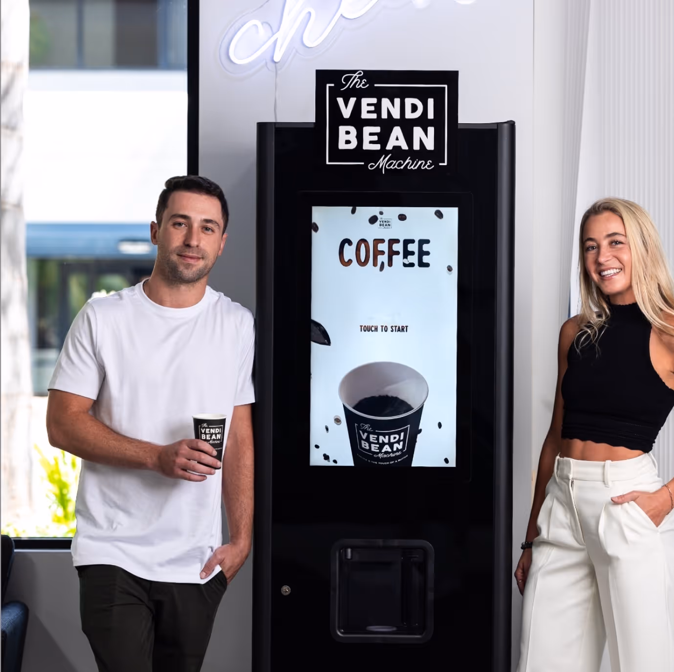 a man and woman standing next to a machine