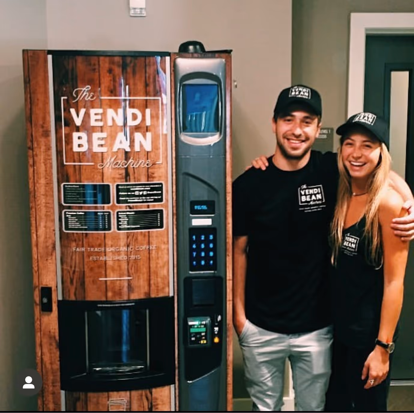 a man and woman standing next to a vending machine