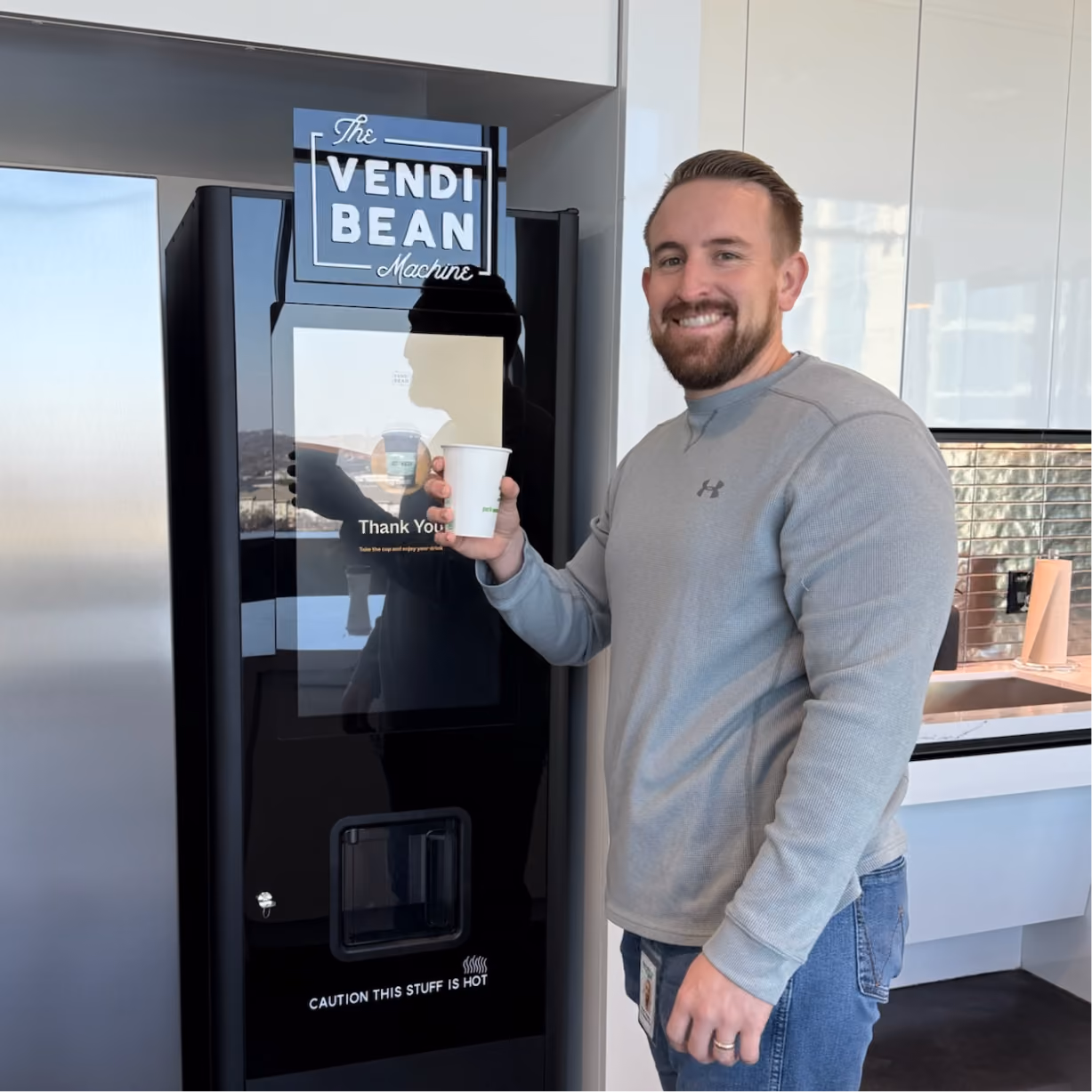 a man holding a cup of coffee