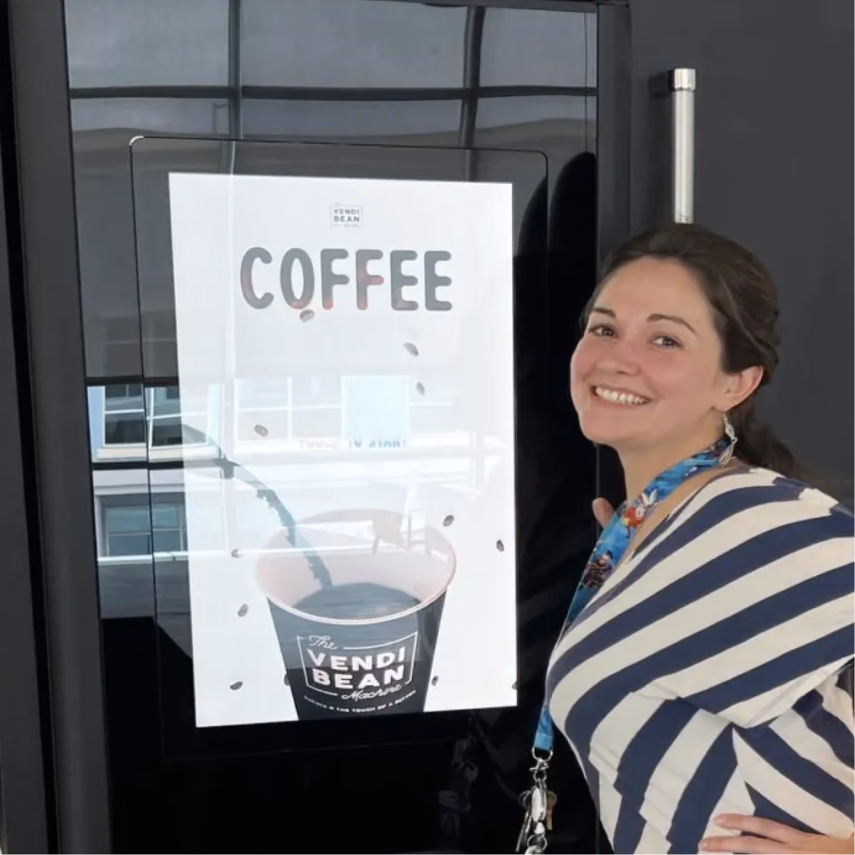 a woman standing next to a sign