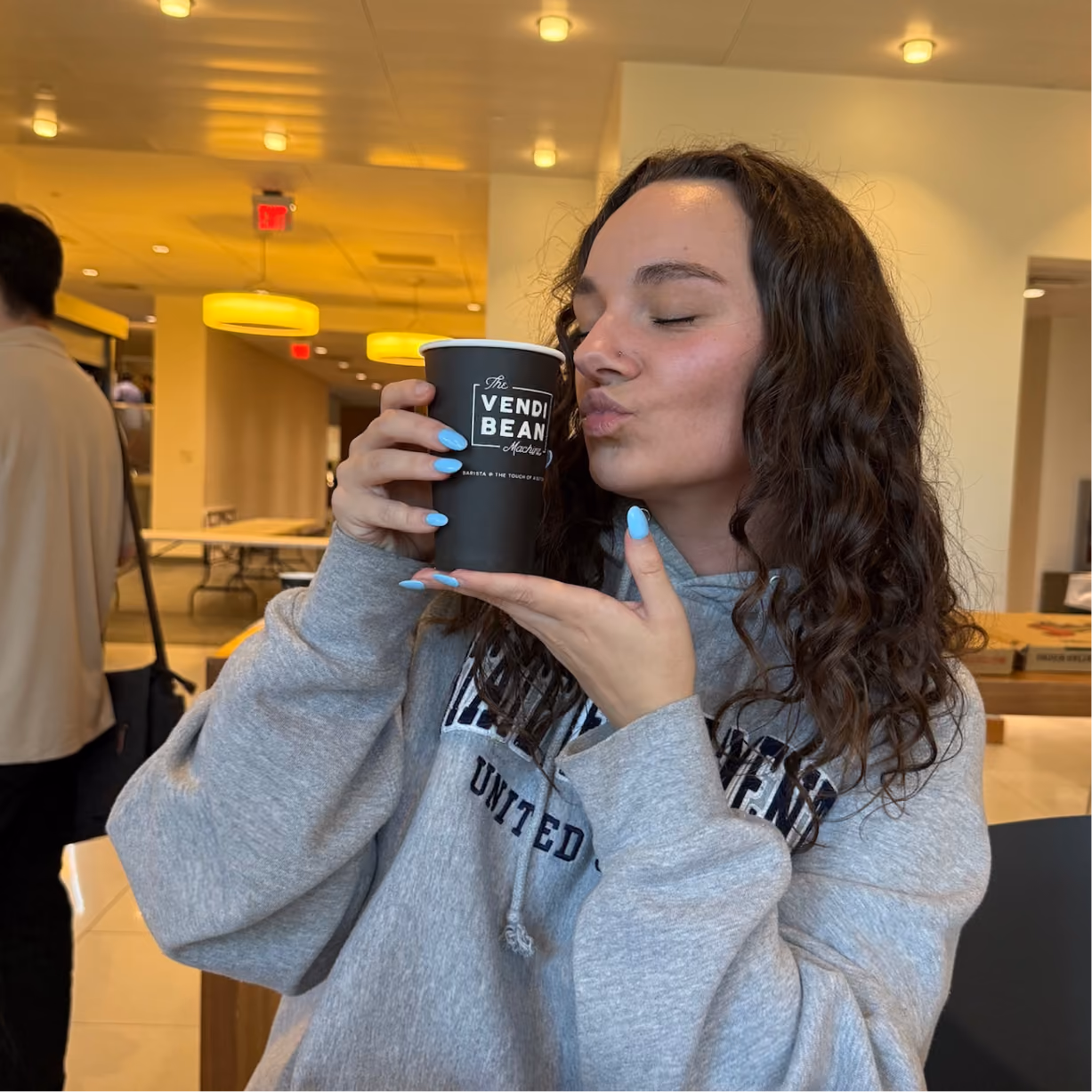 a woman holding a cup of coffee