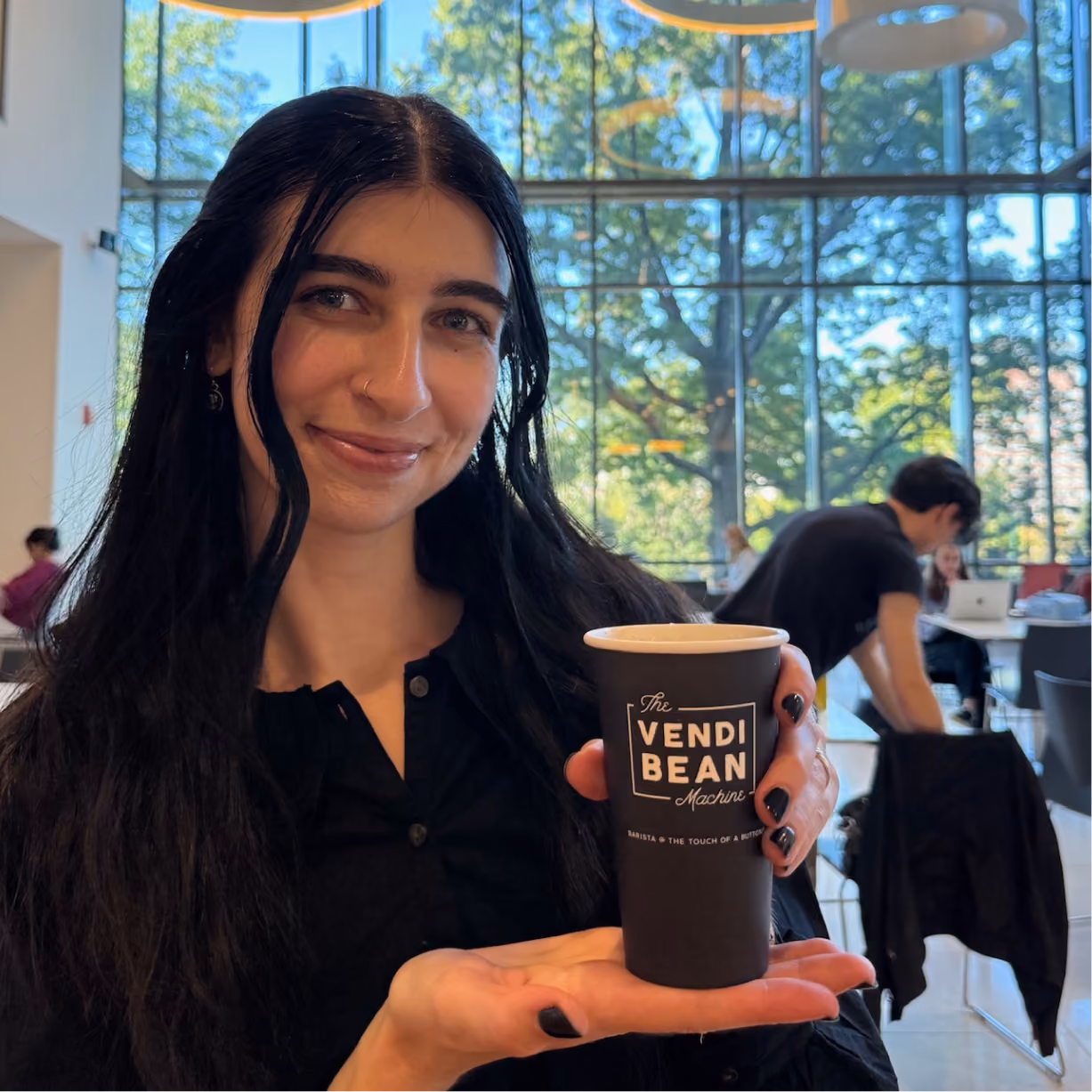 a woman holding a cup of coffee