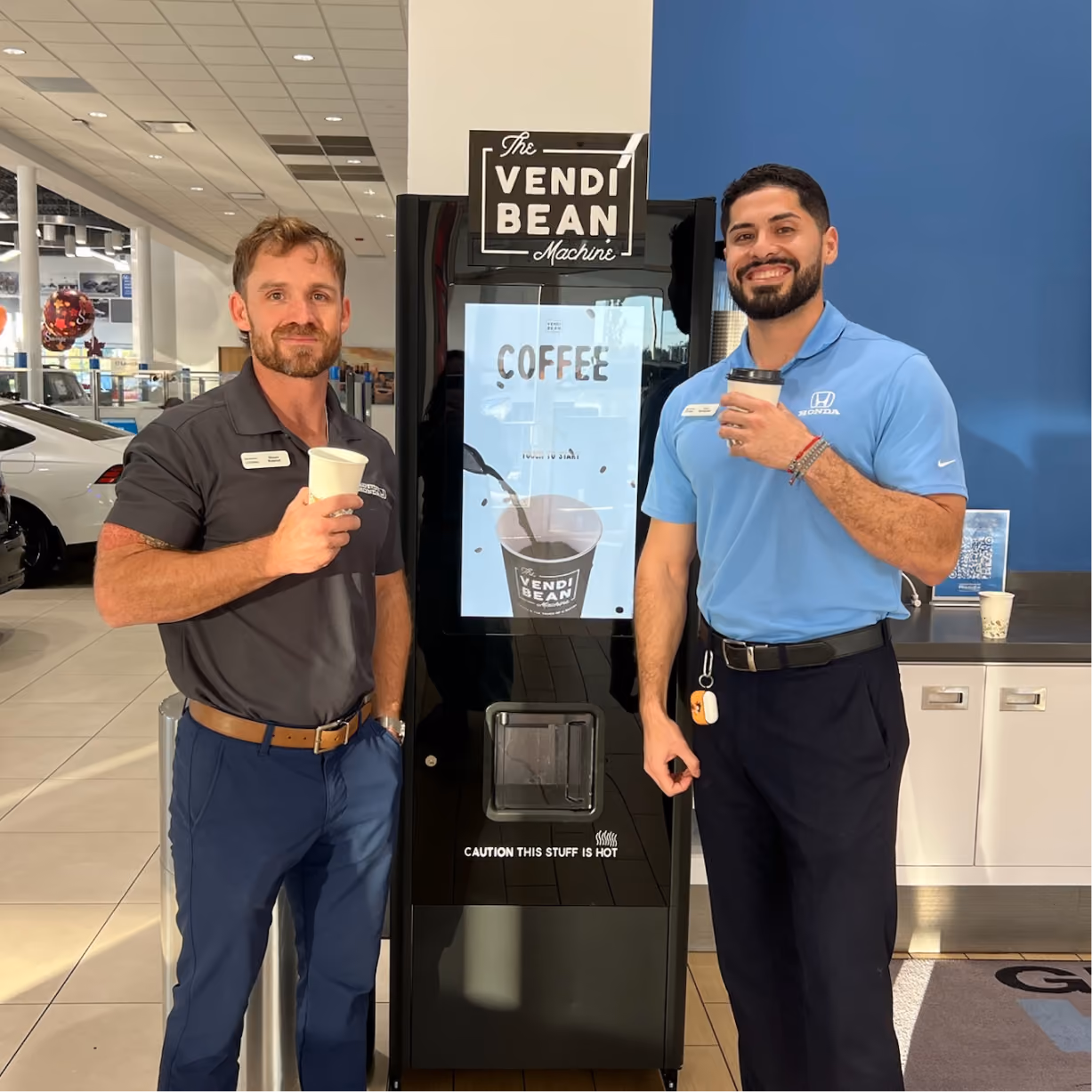 two men standing next to a machine