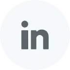 LinkedIn logo in gray on a white circular background.