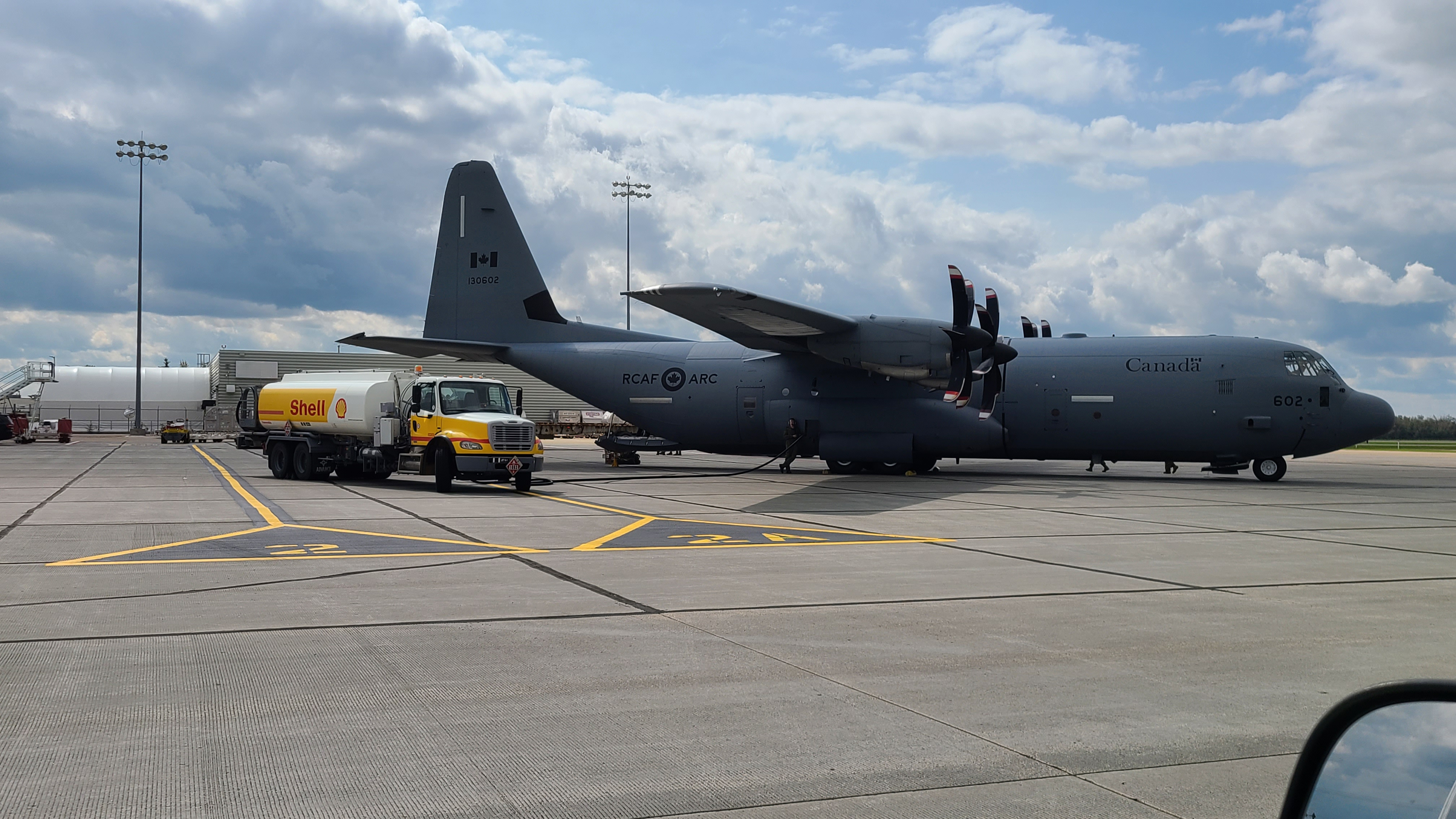 Shell aviation fuel truck refuelling a Royal Canadian Air Force C-130 Hercules aircraft