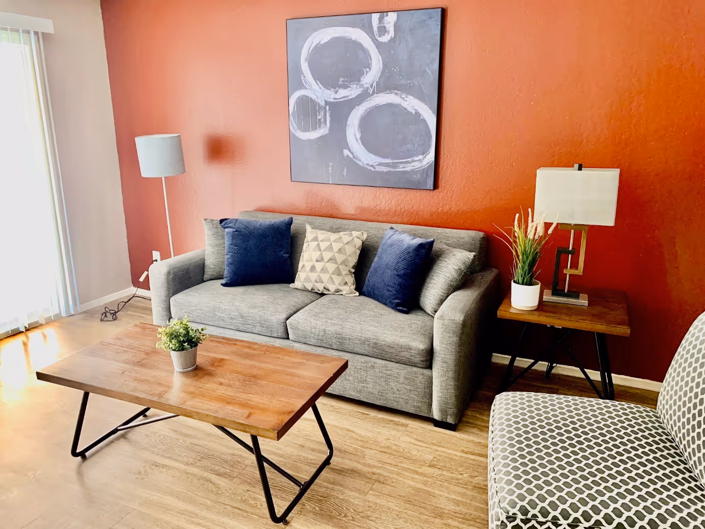 Living area with sofa, coffee table, wall art, and lamp