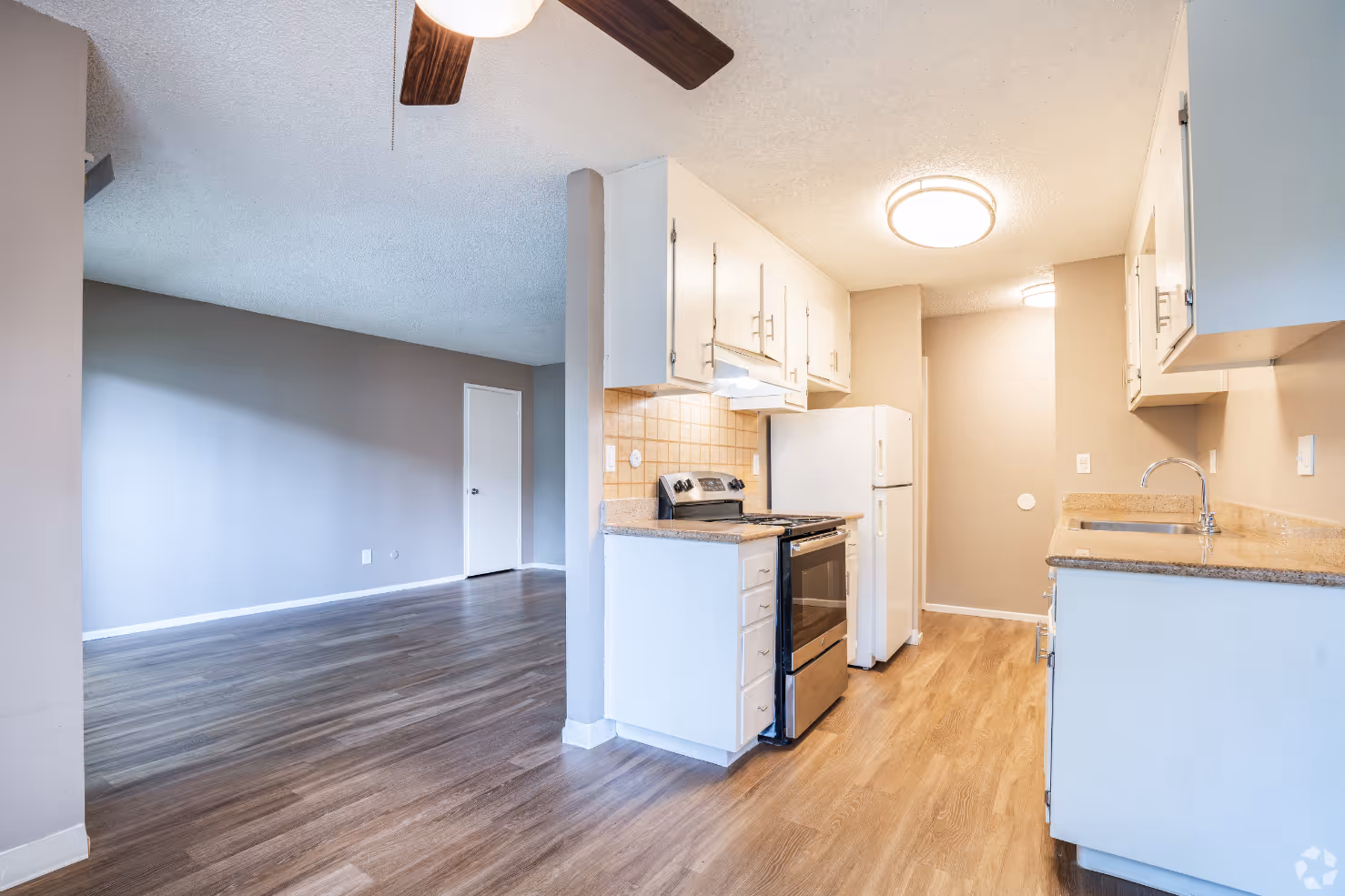 View of unfurnished living area and kitchen