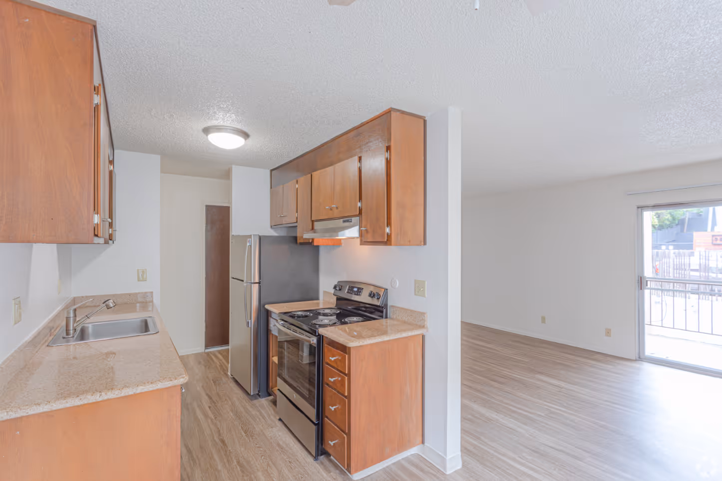 Unfurnished living area with view of dining and kitchen area