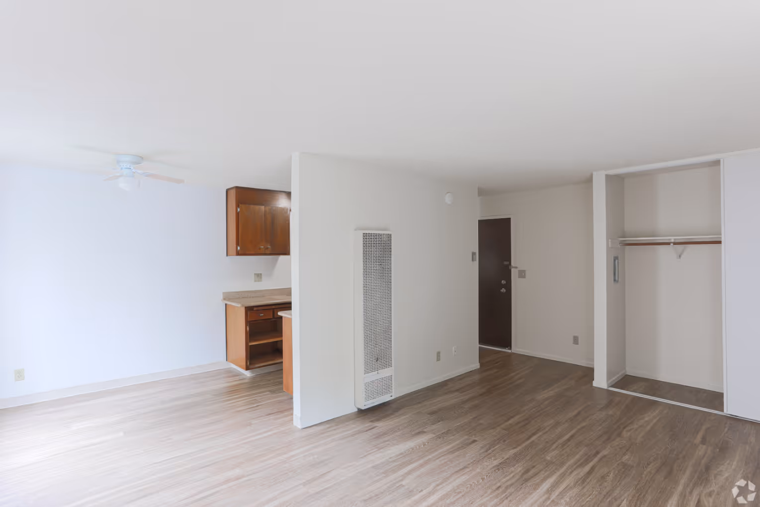 Unfurnished living area with view of dining and kitchen area