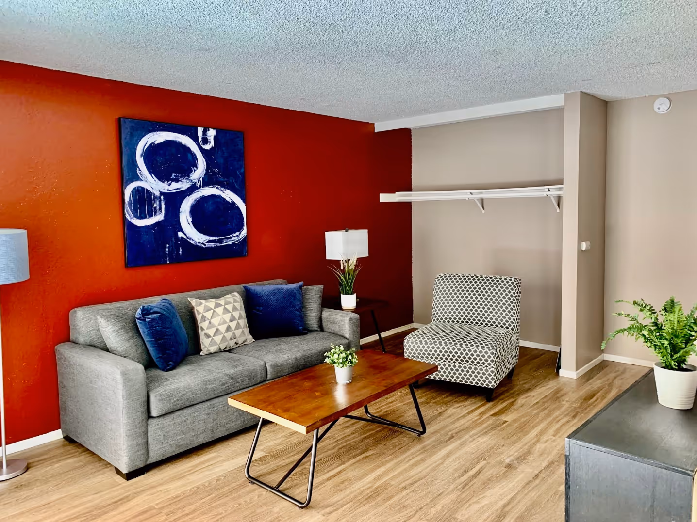 Living area furnished with sofa, coffee table, and wall art