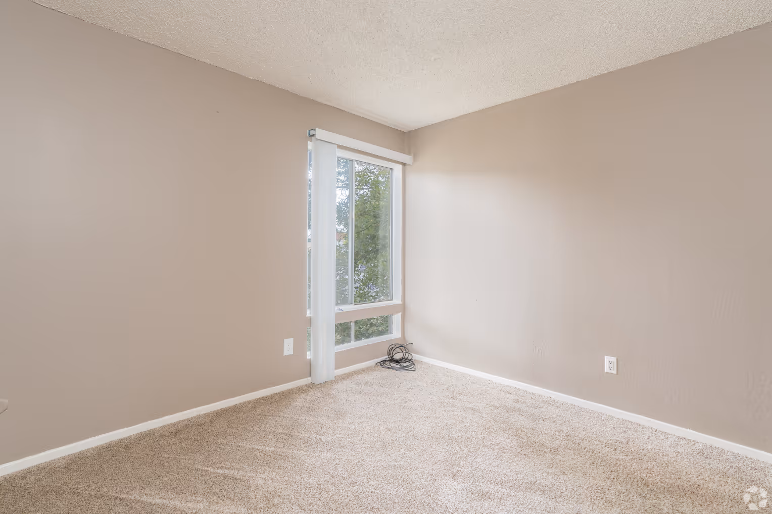Unfurnished bedroom with large window