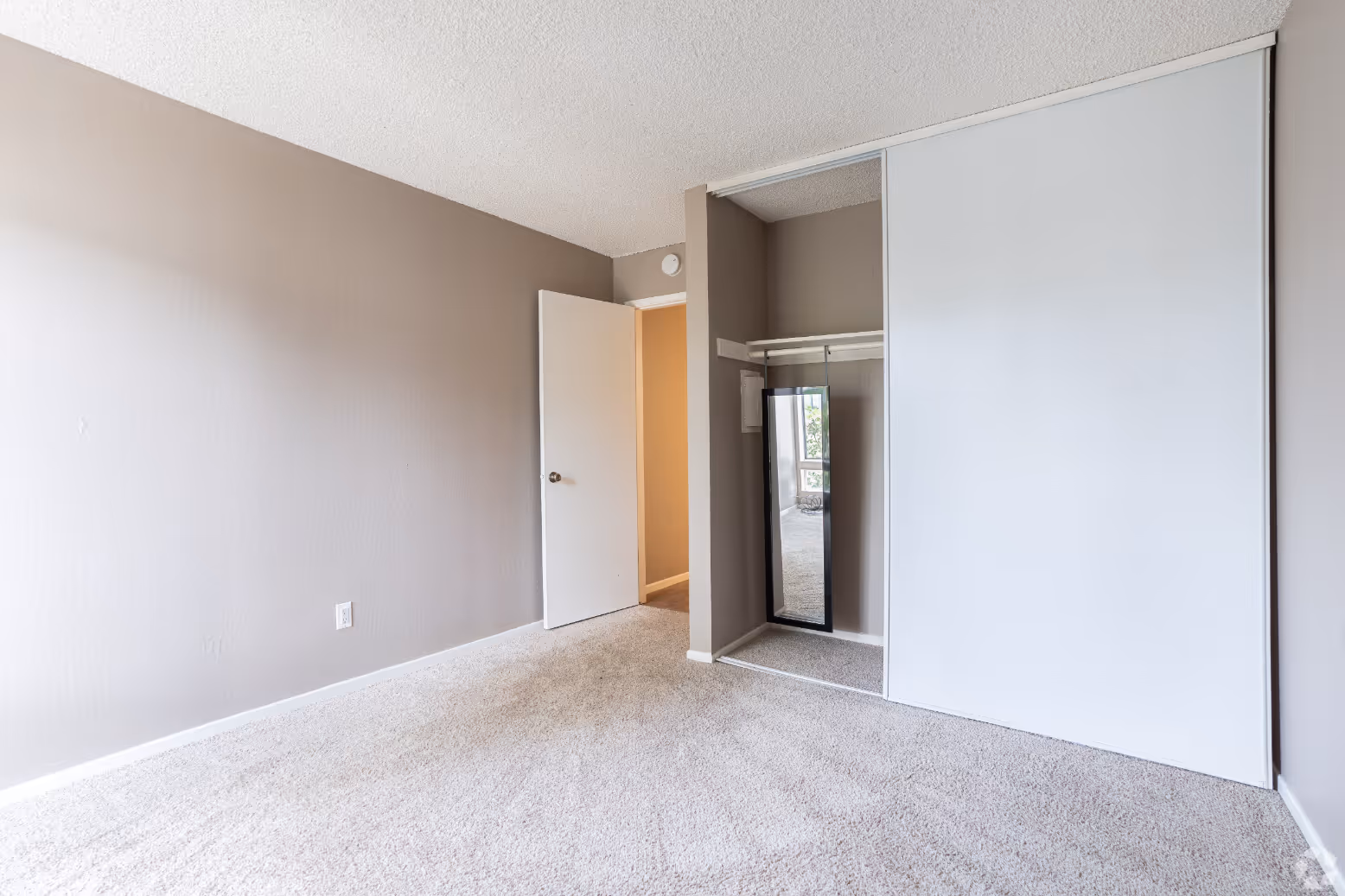 Bedroom with closet with mirror