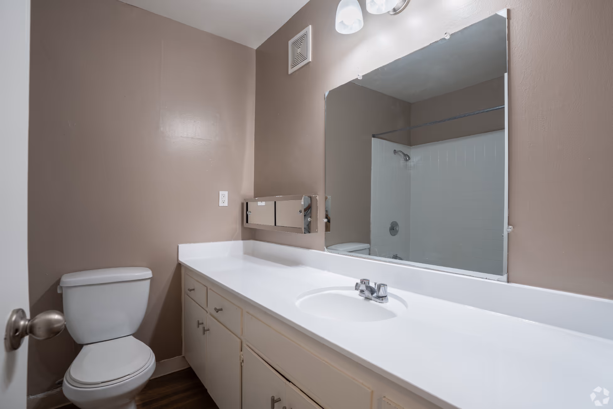 Bathroom with white cabinets and vanity mirror
