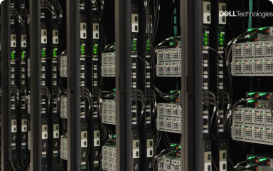 Rows of servers with cables connected in a data center rack, with the Dell Technologies logo in the upper right corner.