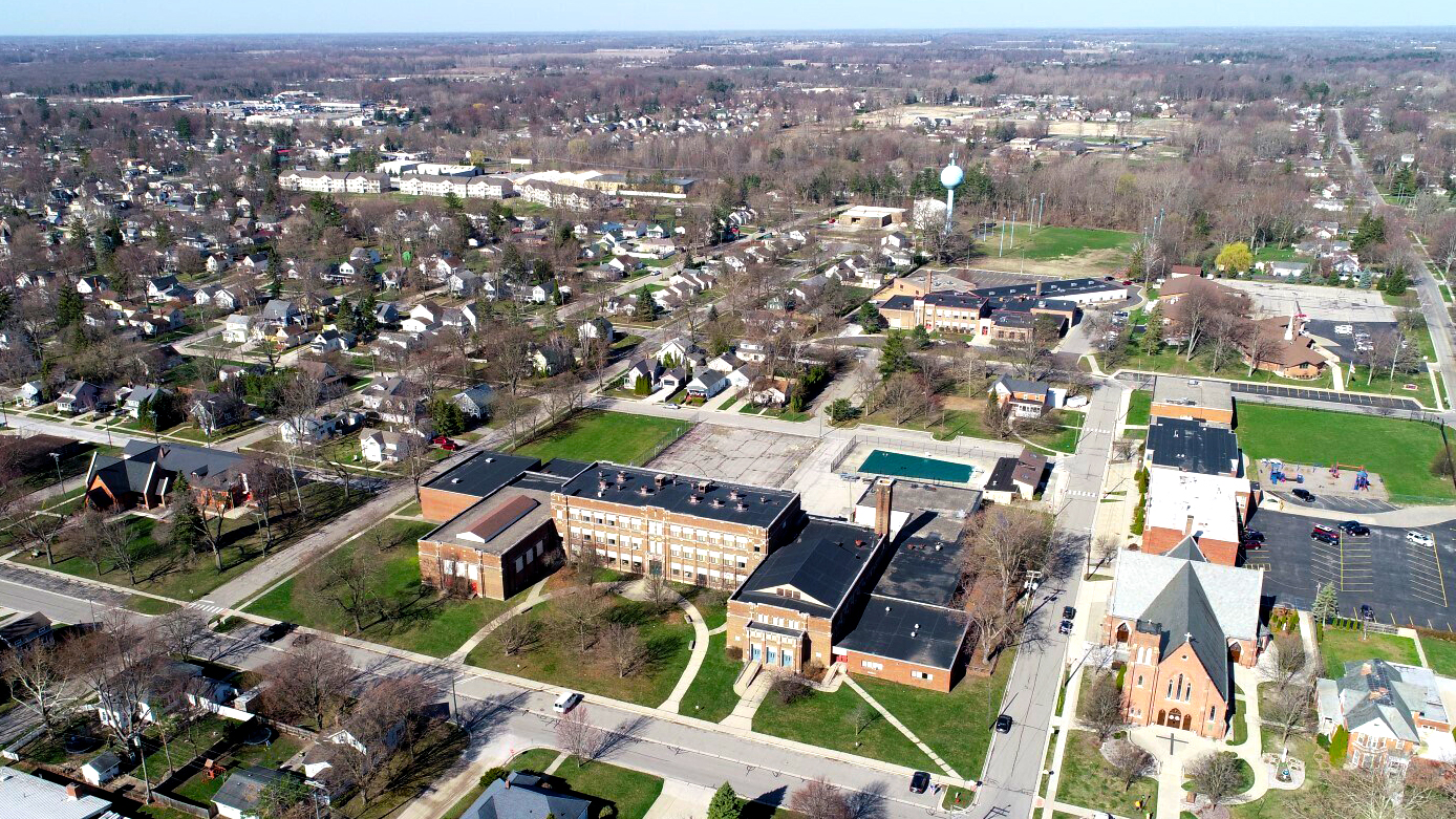 Aerial view of the St. Clair suburban neighborhood with houses, St. Ferdinand's school building and a church.