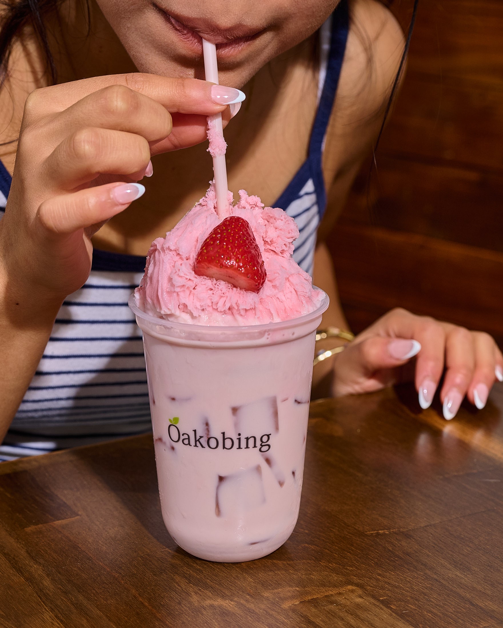 Branded Oakobing strawberry drink cup with a straw, the cold drink side of the menu