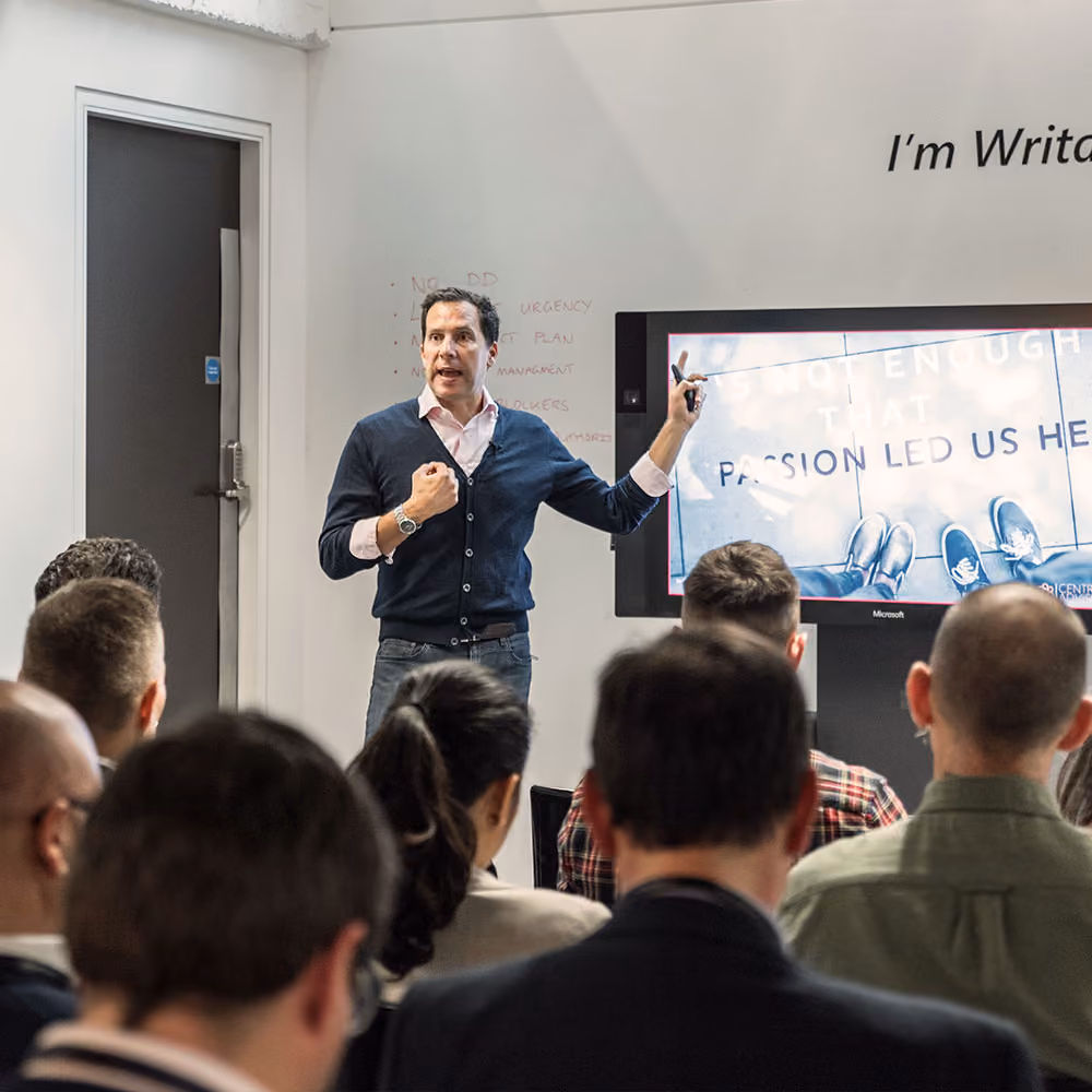 Speaker in front of a group in a workshop meeting