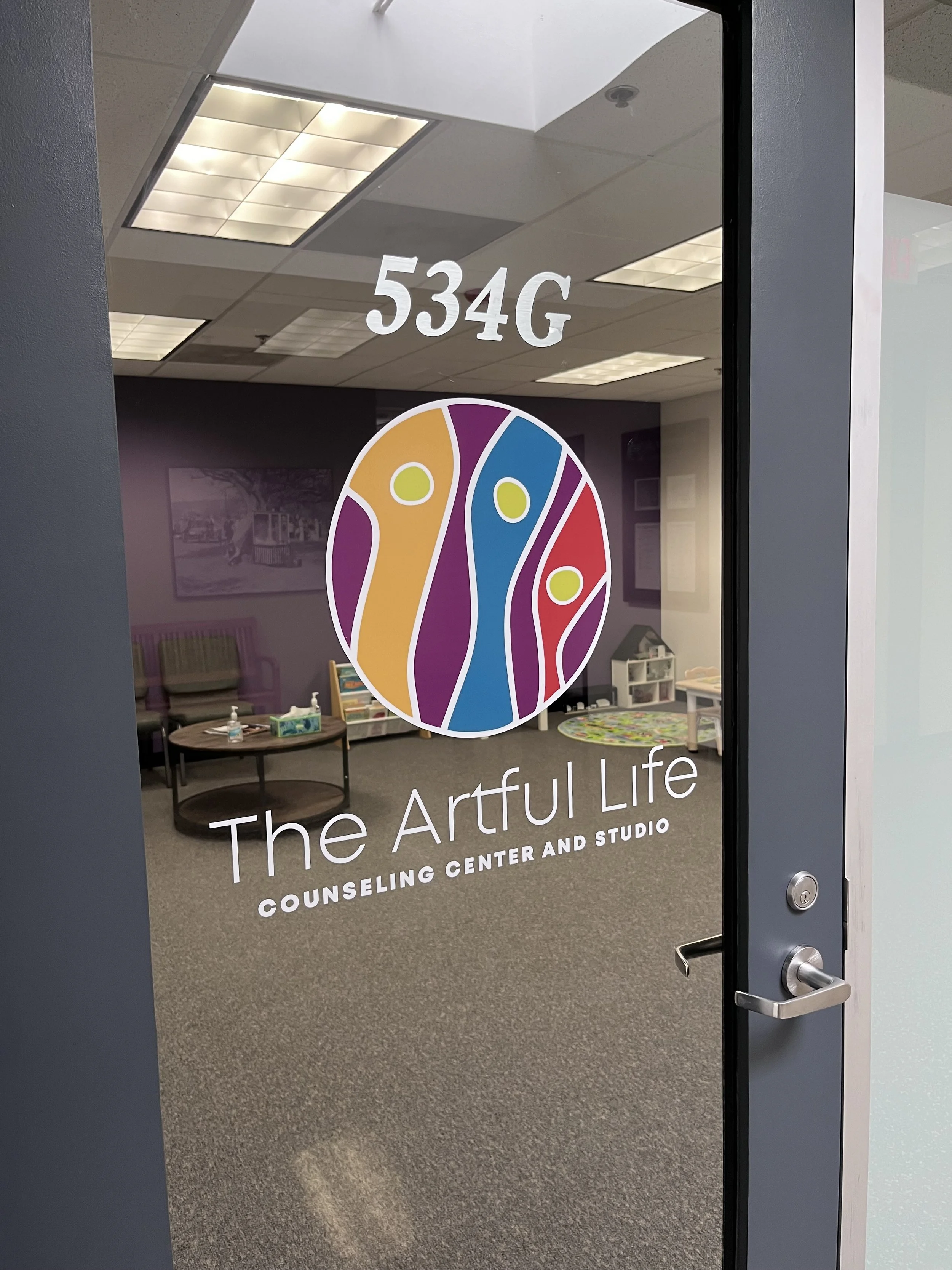 Glass door with 534G and The Artful Life Counseling Center and Studio logo and text.