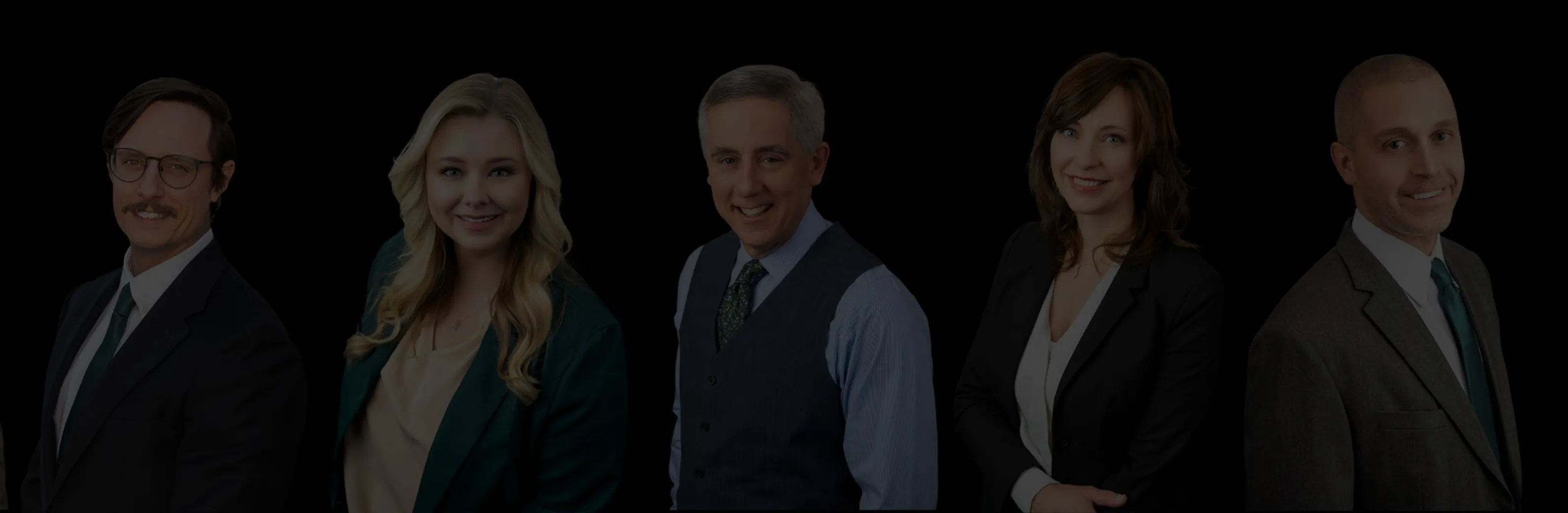 The Cantrell Law Firm attorneys standing in a row against a black background, smiling at the camera.