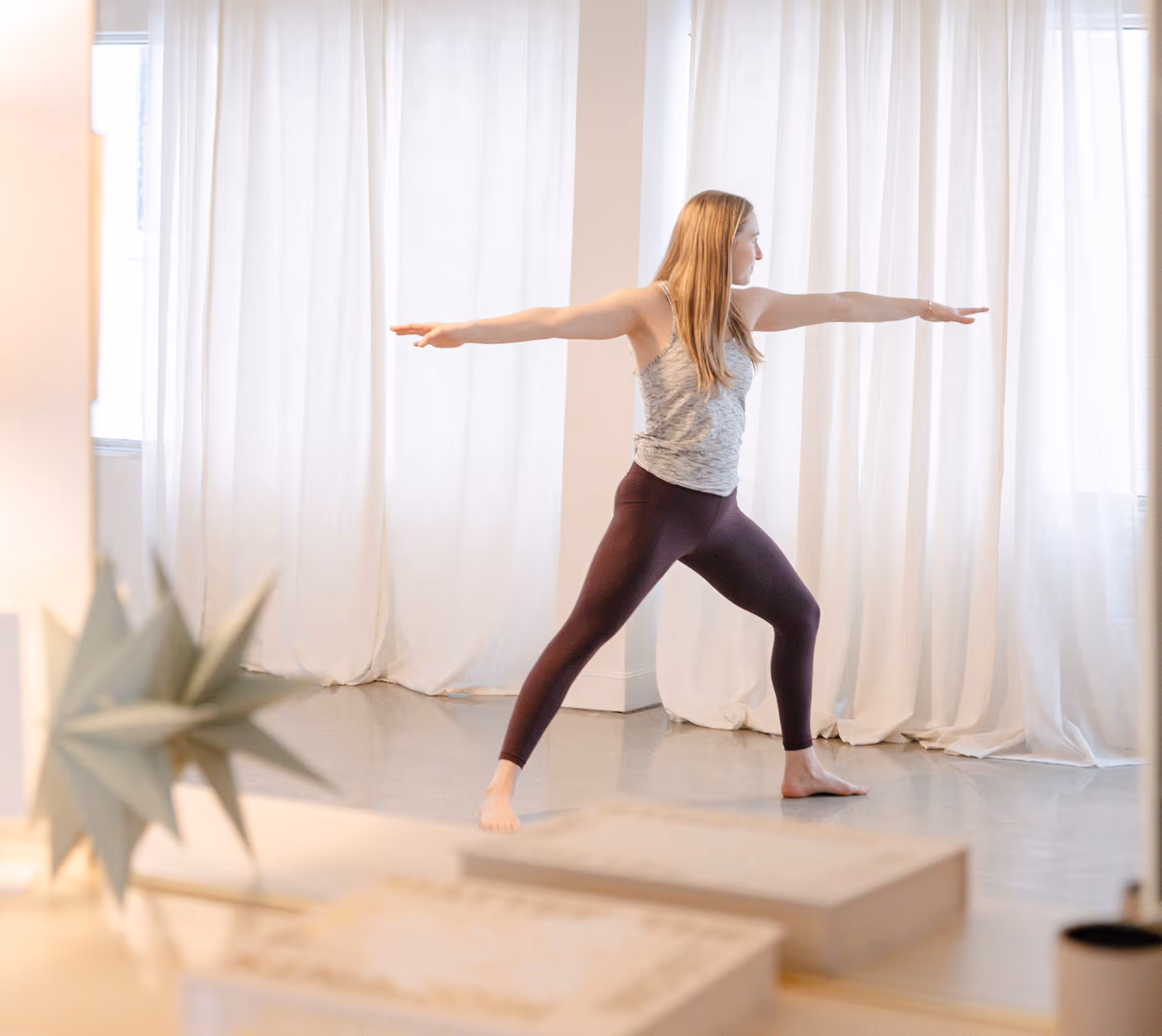 Teen therapy and mindfulness studio at Playful Pathways with a young person practicing a warrior II yoga pose