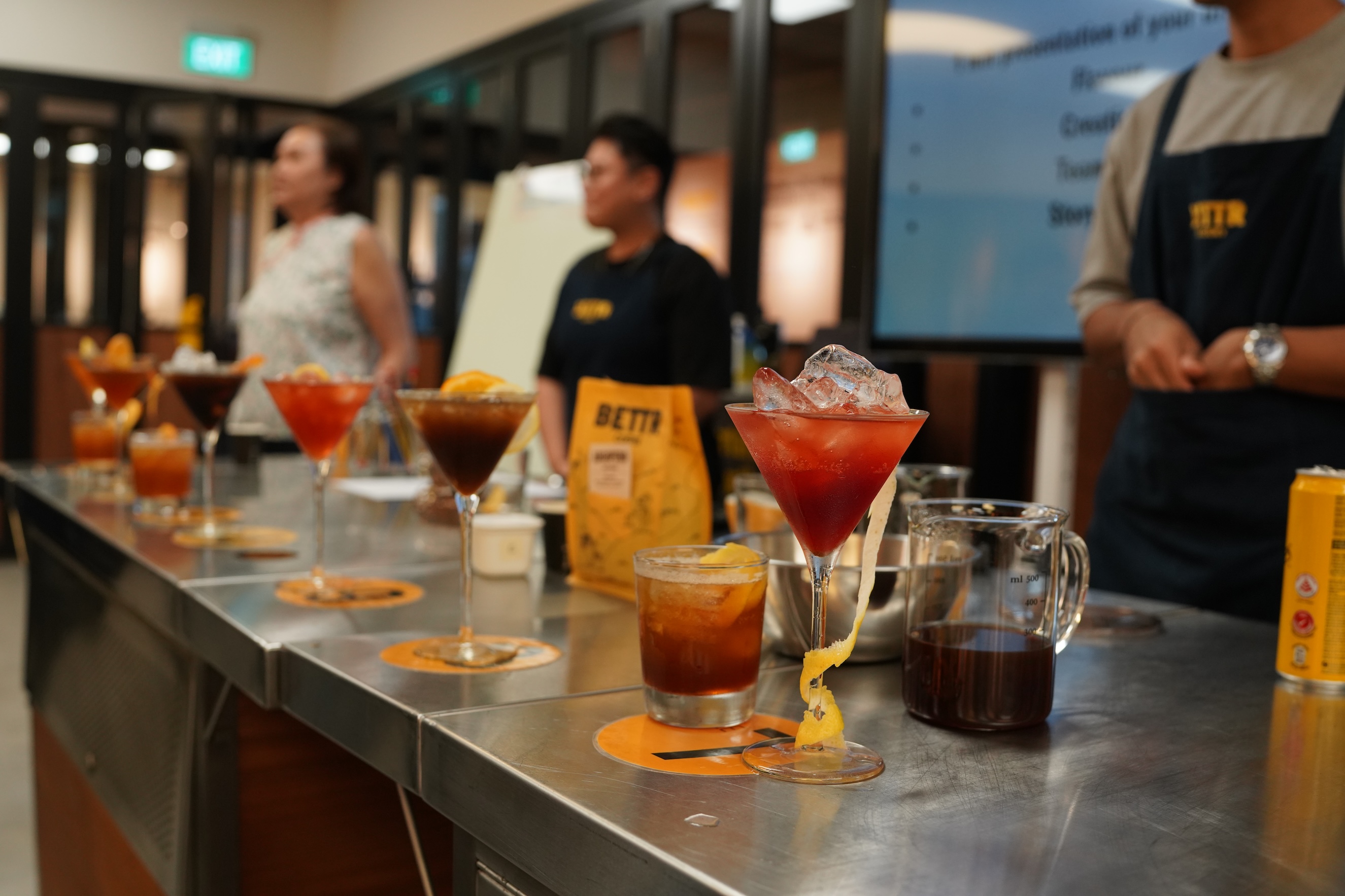 Glasses of cocktail lined up on a table